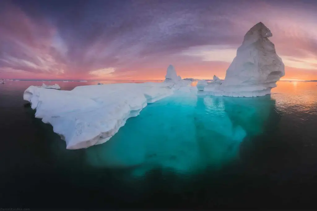 Azure blue iceberg in clear waters of Disko Bay