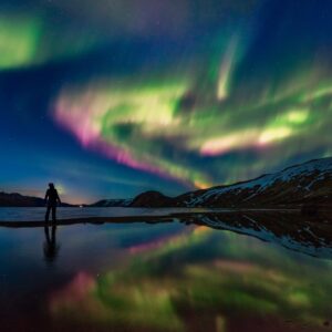 Man admiring the Northern Lights in Iceland