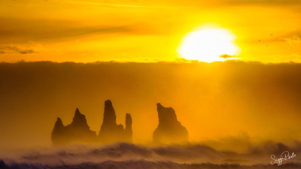 Sunset over the sea stacks at Reynisfjara Beach in Iceland