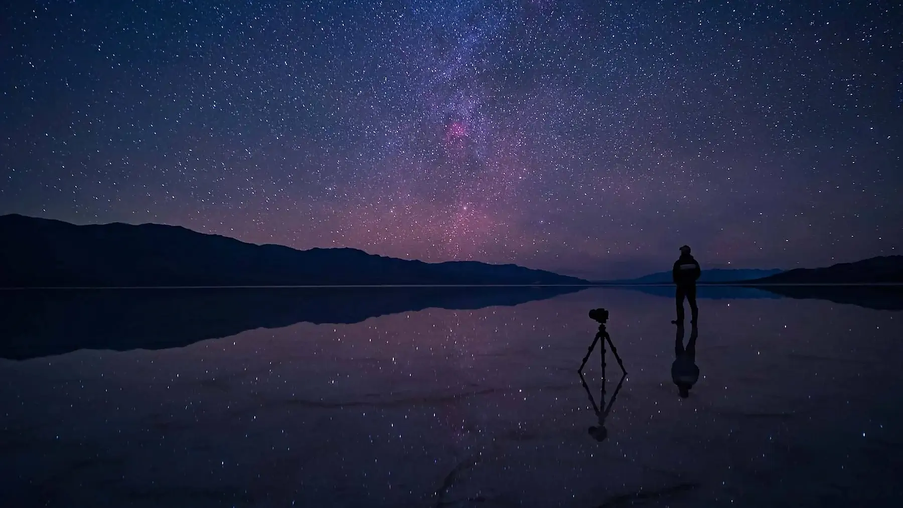 Man standing under the stars in Death Valley